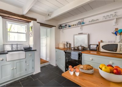 Kitchen with view of cooker, microwave and breakfast table