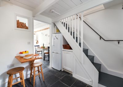 Kitchen with view of stairs and breakfast table